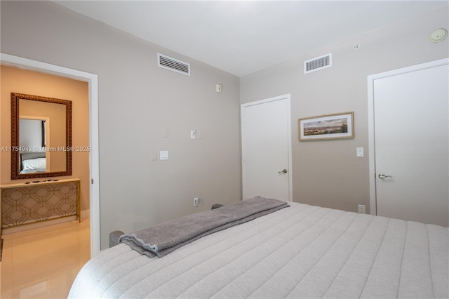 bedroom with visible vents and connected bathroom