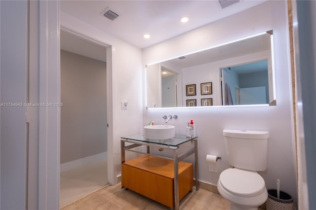 bathroom featuring toilet, recessed lighting, visible vents, and vanity