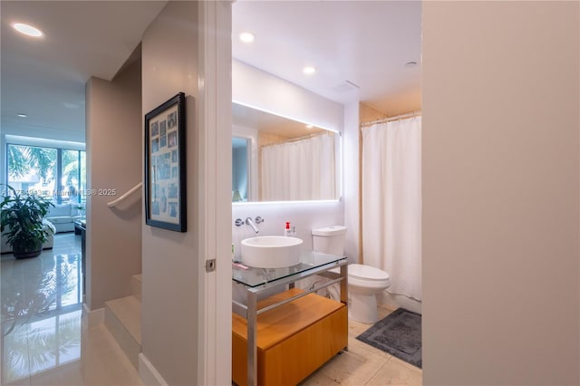 bathroom with curtained shower, tile patterned flooring, toilet, recessed lighting, and vanity