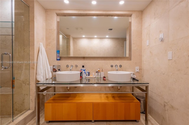 full bath featuring recessed lighting, a sink, a shower stall, and double vanity