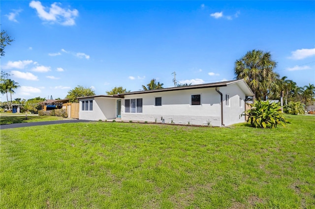 view of front of home with a front lawn and stucco siding