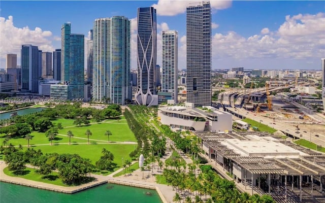 birds eye view of property featuring a view of city and a water view