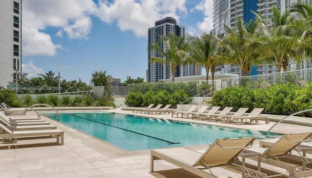 pool featuring fence and a patio