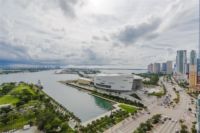 birds eye view of property with a water view and a city view