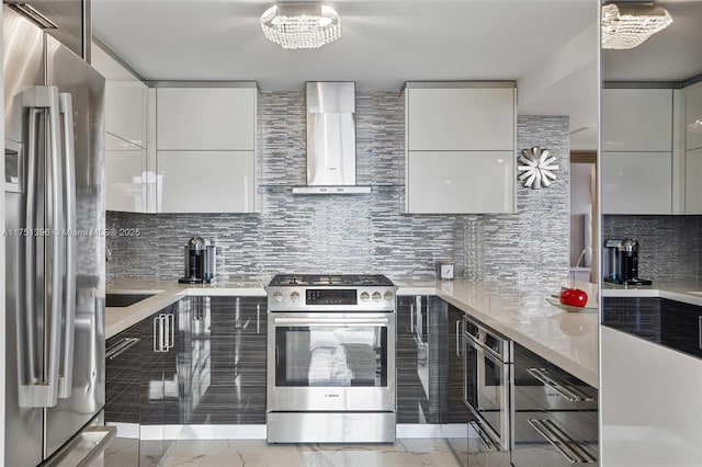 kitchen featuring appliances with stainless steel finishes, modern cabinets, and wall chimney range hood