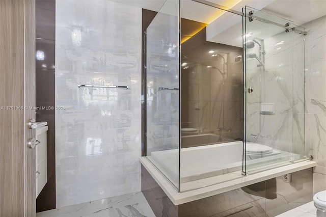 bathroom featuring marble finish floor, a marble finish shower, toilet, and tile walls