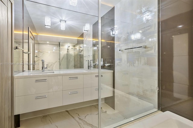 bathroom with a stall shower, marble finish floor, a sink, and double vanity