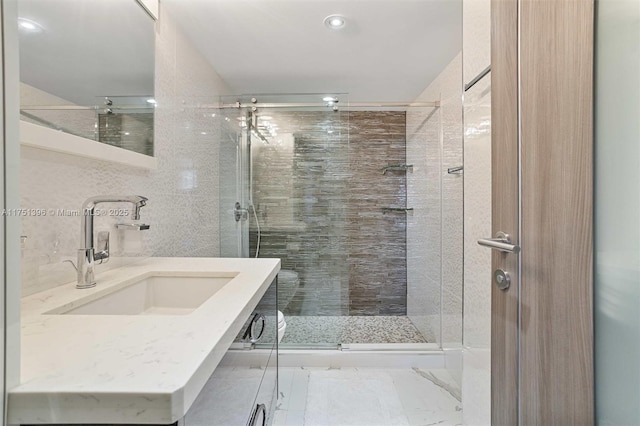 full bathroom featuring a shower stall, vanity, and tile walls