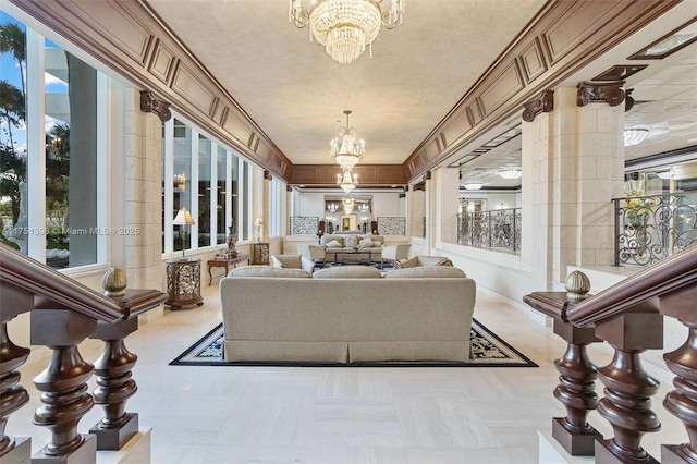 living area featuring plenty of natural light and a notable chandelier