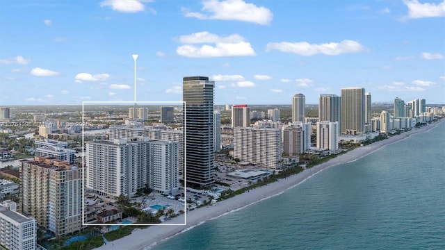 bird's eye view with a water view, a view of city, and a beach view