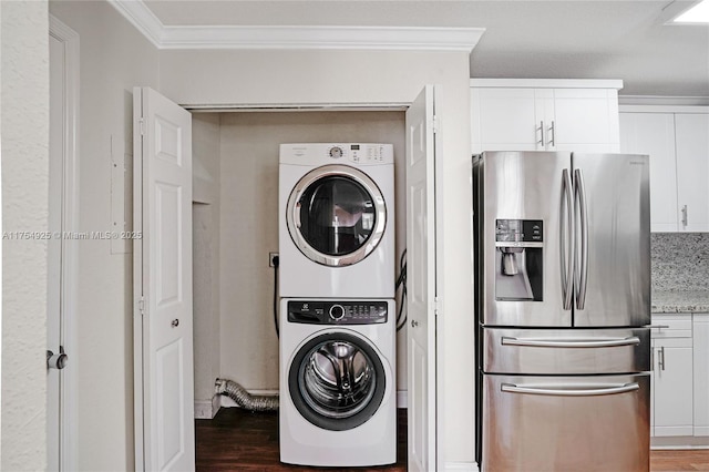 12611 SW 54th Ct Unit 12611, Miramar, FL 33027 - washroom with stacked washing machine and dryer, crown molding, and wood finished floors