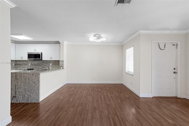 12611 SW 54th Ct Unit 12611, Miramar, FL 33027 - unfurnished living room with dark wood-style flooring, ornamental molding, and a textured ceiling