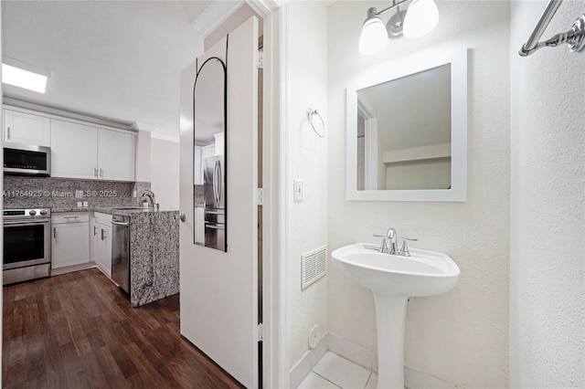 12611 SW 54th Ct Unit 12611, Miramar, FL 33027 - bathroom featuring wood finished floors and backsplash