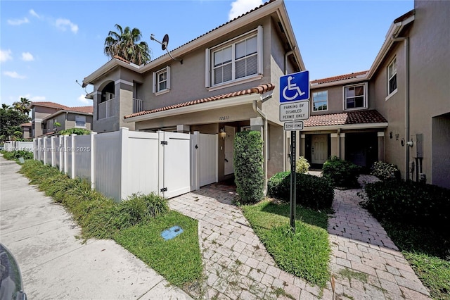 12611 SW 54th Ct Unit 12611, Miramar, FL 33027 - view of front facade featuring a gate, stucco siding, and a tile roof