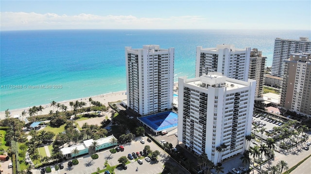 bird's eye view featuring a water view, a beach view, and a city view