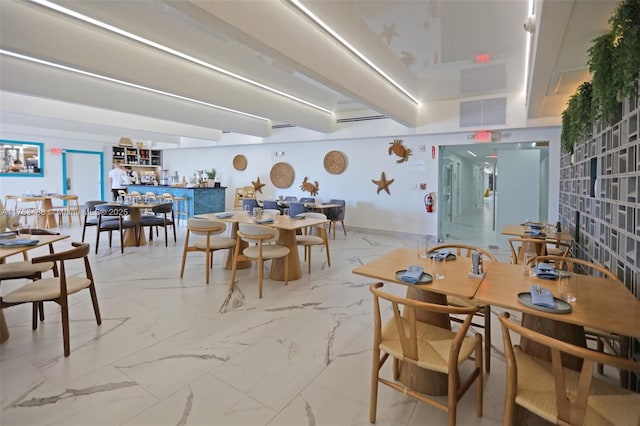 dining space with marble finish floor, visible vents, and baseboards