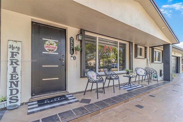 doorway to property featuring stucco siding