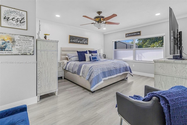 bedroom featuring light wood-type flooring, a ceiling fan, baseboards, and crown molding