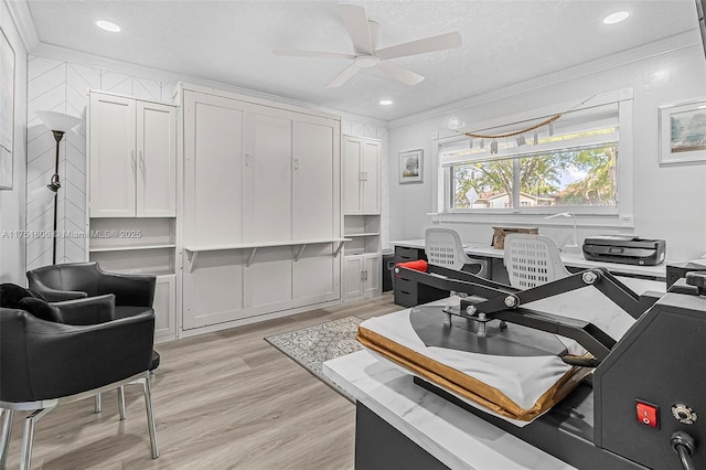 office space with ceiling fan, light wood finished floors, a textured ceiling, and crown molding