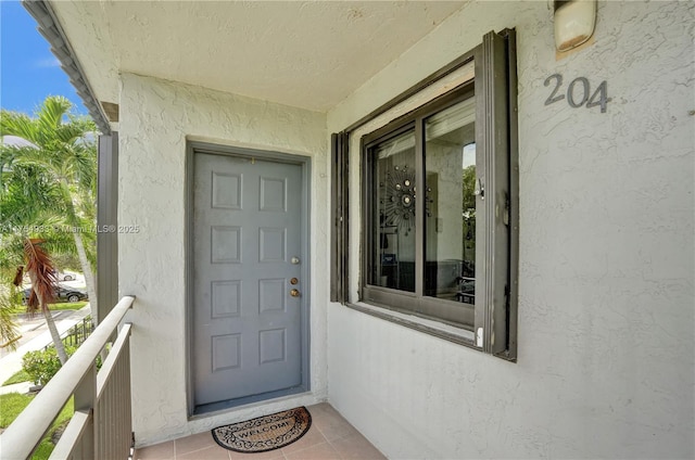 property entrance with stucco siding