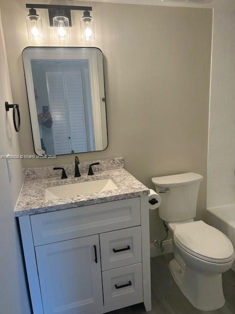 full bathroom with baseboards, vanity, toilet, and wood finished floors