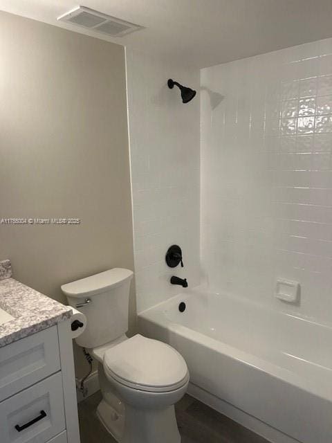 bathroom with visible vents, toilet, wood finished floors, bathtub / shower combination, and vanity