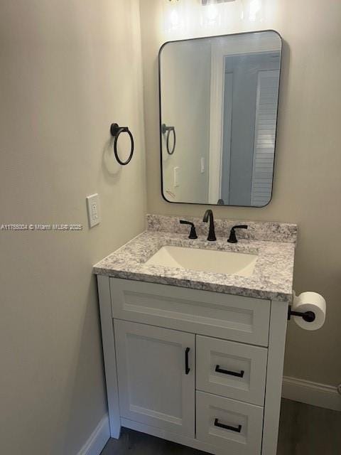 bathroom with vanity and baseboards