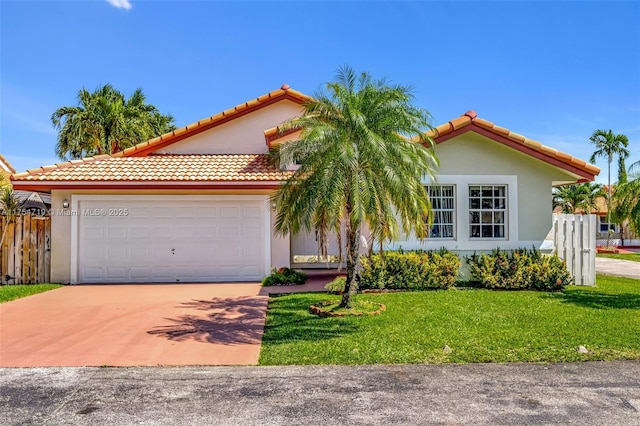 view of front of home with driveway, a front lawn, fence, and stucco siding