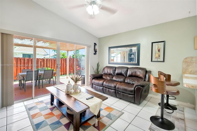 living room with light tile patterned floors, baseboards, vaulted ceiling, and a ceiling fan