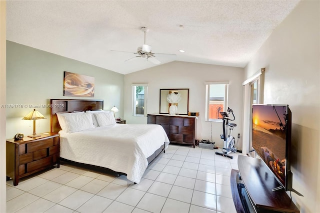 bedroom with ceiling fan, vaulted ceiling, a textured ceiling, and light tile patterned floors