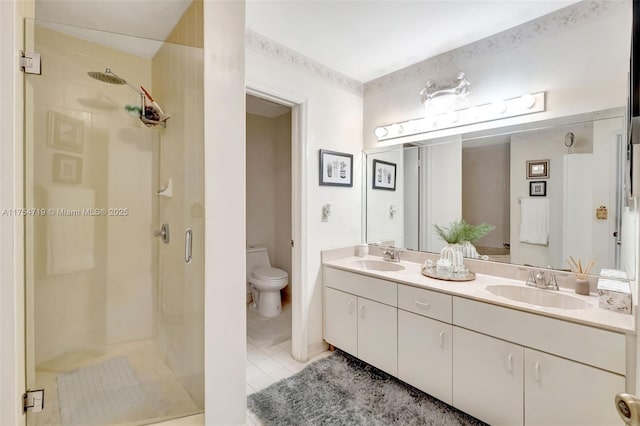 full bathroom with toilet, tile patterned flooring, a shower stall, and a sink