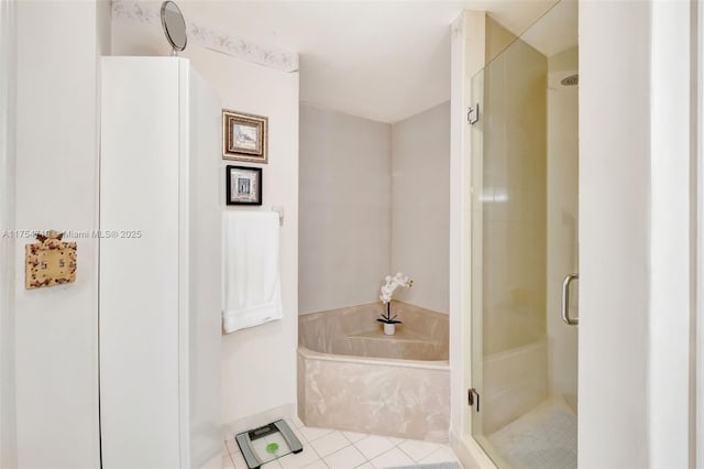 full bathroom featuring a garden tub, a stall shower, and tile patterned flooring