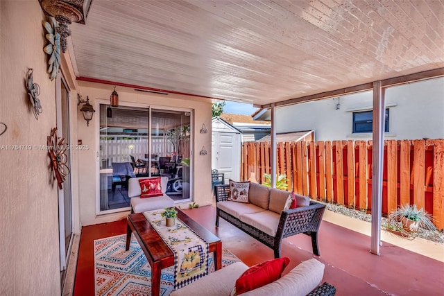 view of patio featuring a shed, fence, an outdoor hangout area, and an outdoor structure