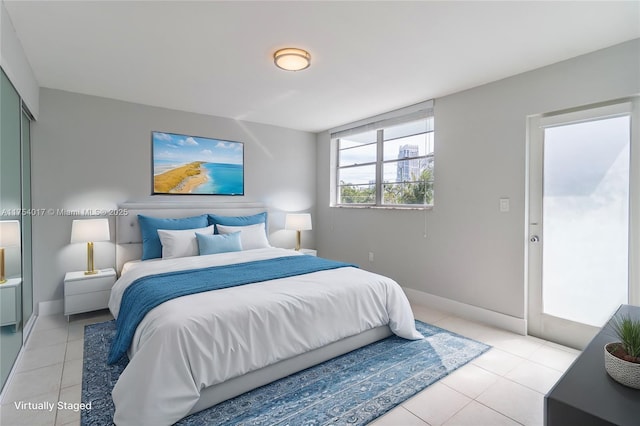 bedroom featuring light tile patterned flooring and baseboards