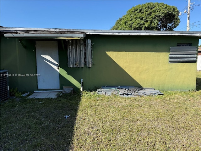 view of property exterior featuring a yard and stucco siding