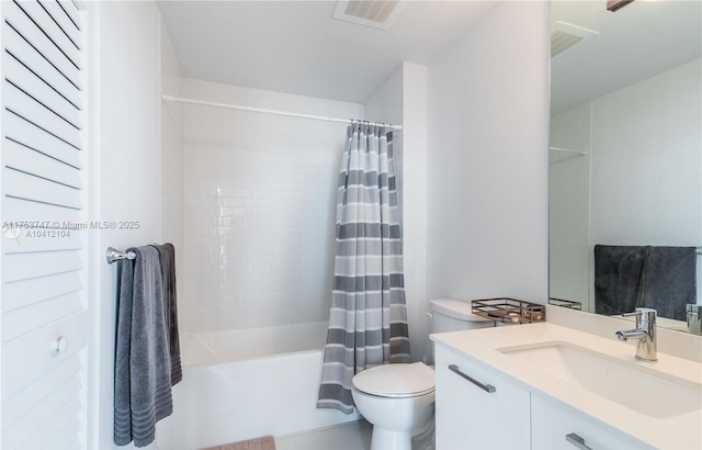 bathroom featuring toilet, vanity, shower / bath combo with shower curtain, and visible vents