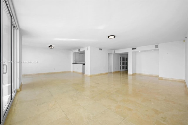 spare room with visible vents and baseboards