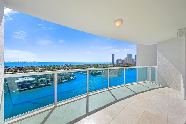 balcony with a water view and a city view