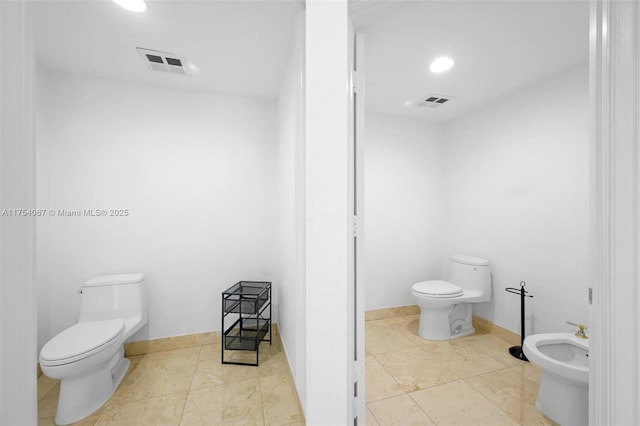 bathroom featuring visible vents, a bidet, toilet, and tile patterned floors