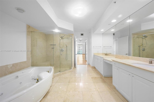 full bath with a stall shower, tile patterned flooring, a jetted tub, and vanity