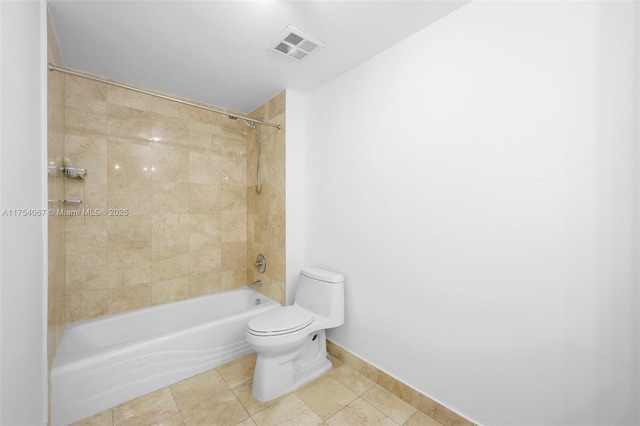 bathroom with baseboards, visible vents, toilet, tile patterned floors, and washtub / shower combination