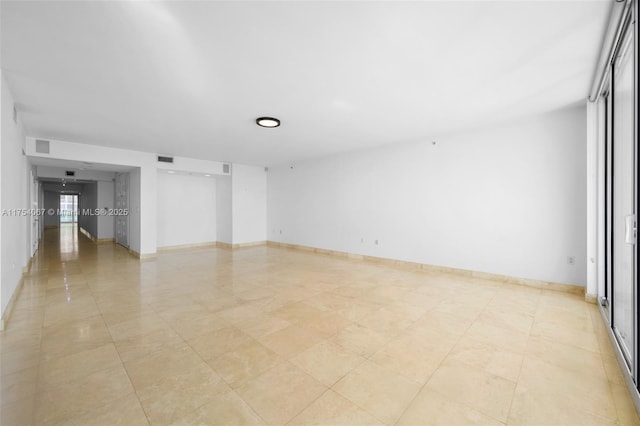 unfurnished room featuring visible vents and baseboards