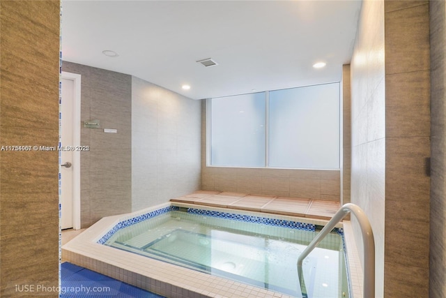 view of pool featuring an indoor hot tub