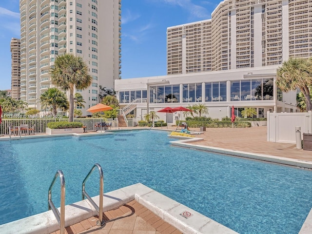 pool featuring a patio and fence