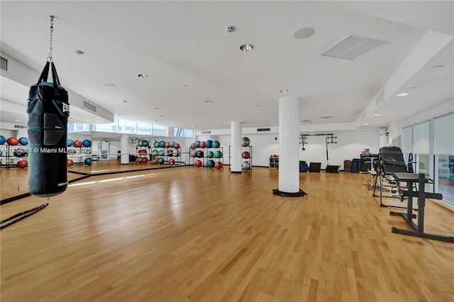 gym featuring light wood finished floors and visible vents