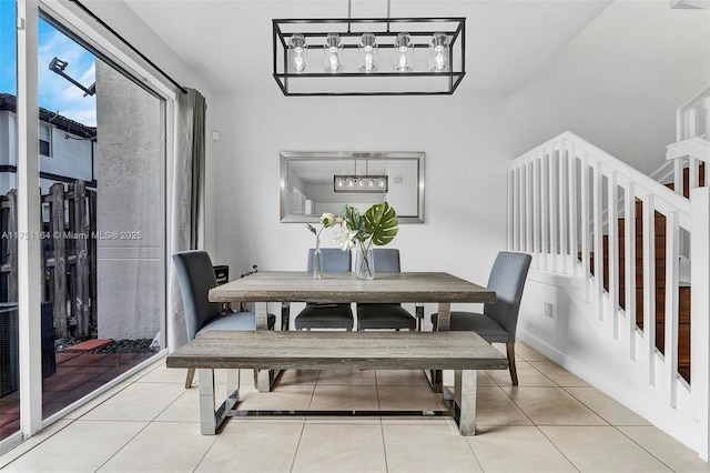 dining space featuring stairway and light tile patterned flooring