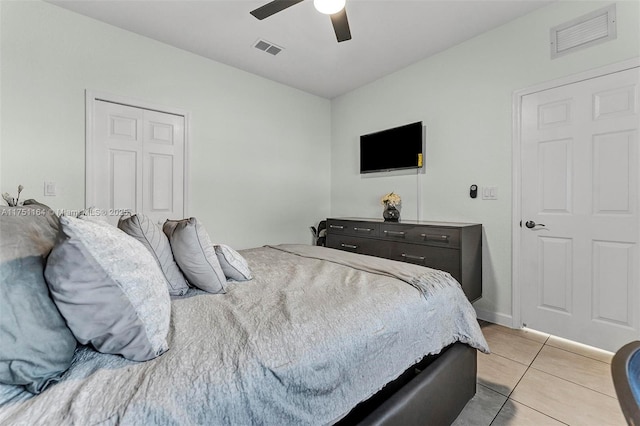 bedroom with light tile patterned floors, visible vents, and a ceiling fan