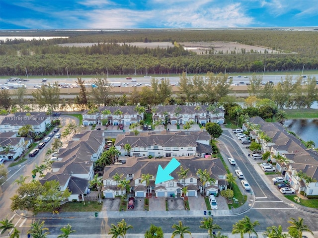 birds eye view of property featuring a water view and a residential view