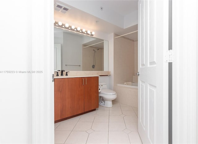 bathroom featuring toilet, vanity, visible vents, shower / washtub combination, and tile patterned floors