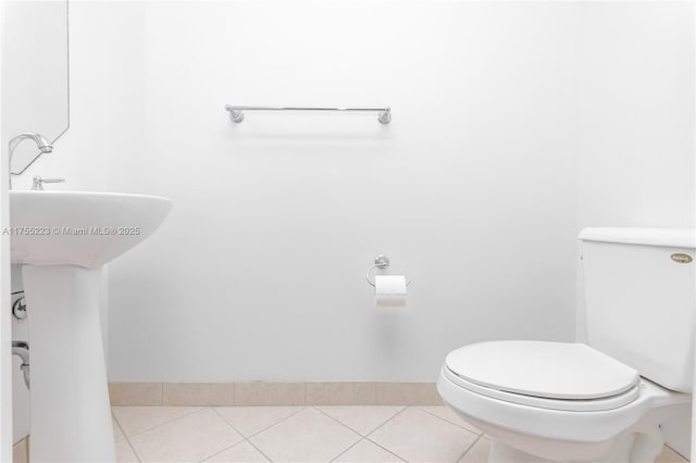 bathroom with toilet and tile patterned floors